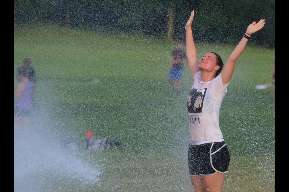 A person comes over to cool off after their ultimate Frisbee game. Tony Saxon/GuelphToday