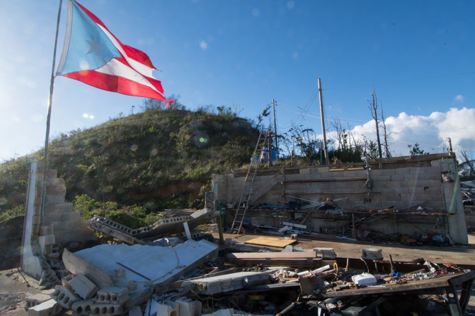 In the mountains of Puerto Rico, a flag flies over a home destroyed by hurricane Maria. Philip Maher