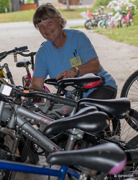 Mary Rife conducts her daily routine of fixing and selling hundreds of bikes each year. Photo courtesy of Philip Maher