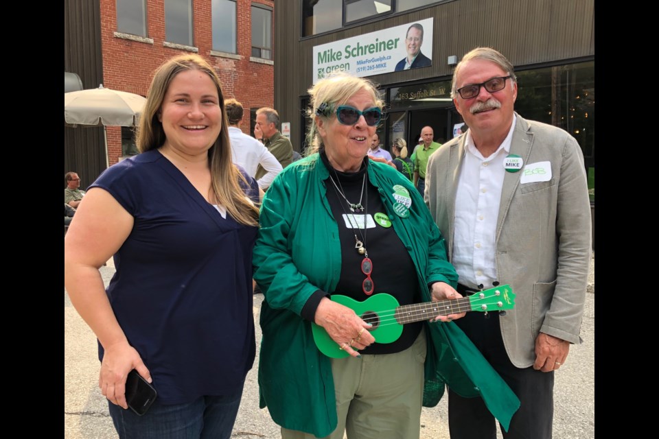 Even Elaine Duignan's ukelele is green at Mike Schreiner's campaign headquarters. From left, campaign manager Becky Smit, Duignan and Green Party founding member Bob Desautels. Photo by Owen Roberts for GuelphToday