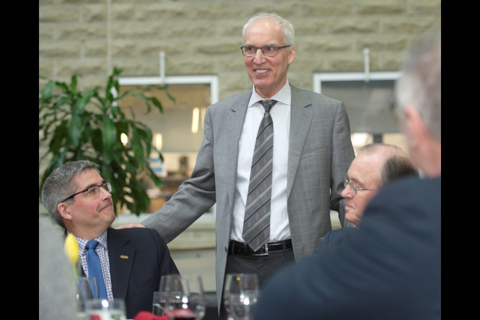 University of Guelph President Franco Vaccarino (standing) visits with researchers John Cranfield (left) and Peter Tremaine. Photo courtesy of Martin Schwalbe