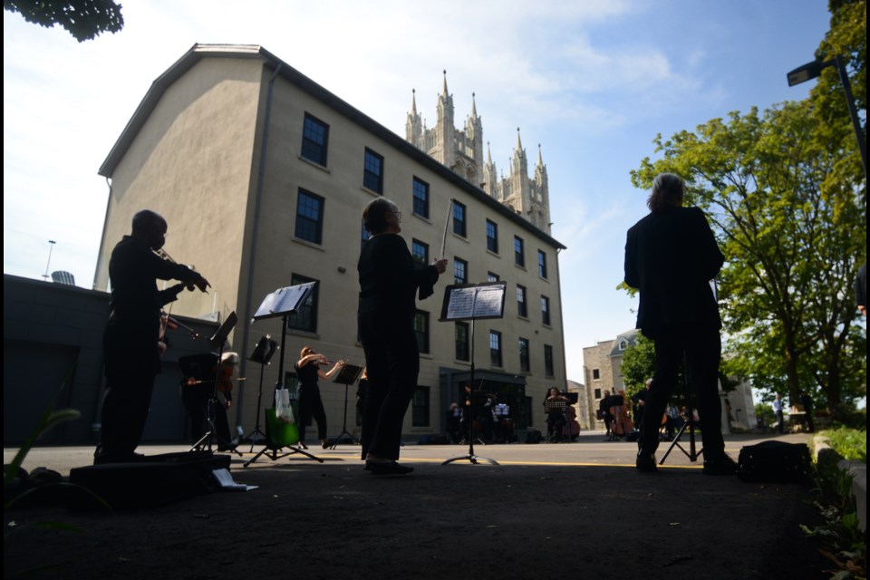 Members of the Guelph Symphony Orchestra perform a free walk-by concert in front of the Rectory on Catholic Hill in Downtown Guelph on Sunday. The night before they performed at the Mustang Drive-In prior to the movies that night. Tony Saxon/GuelphToday