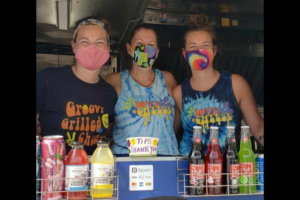 Tammy Wallace (centre) said her food truck is a family affair. Her twin daughters, Jayme (left) and Alex (right) work in the kitchen serving up gooey, groovy grilled cheese sandwiches. 