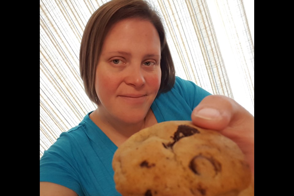 Rachel Crysler holding one of the cookies she makes through her business, 'Rae's Gone Kookie.'