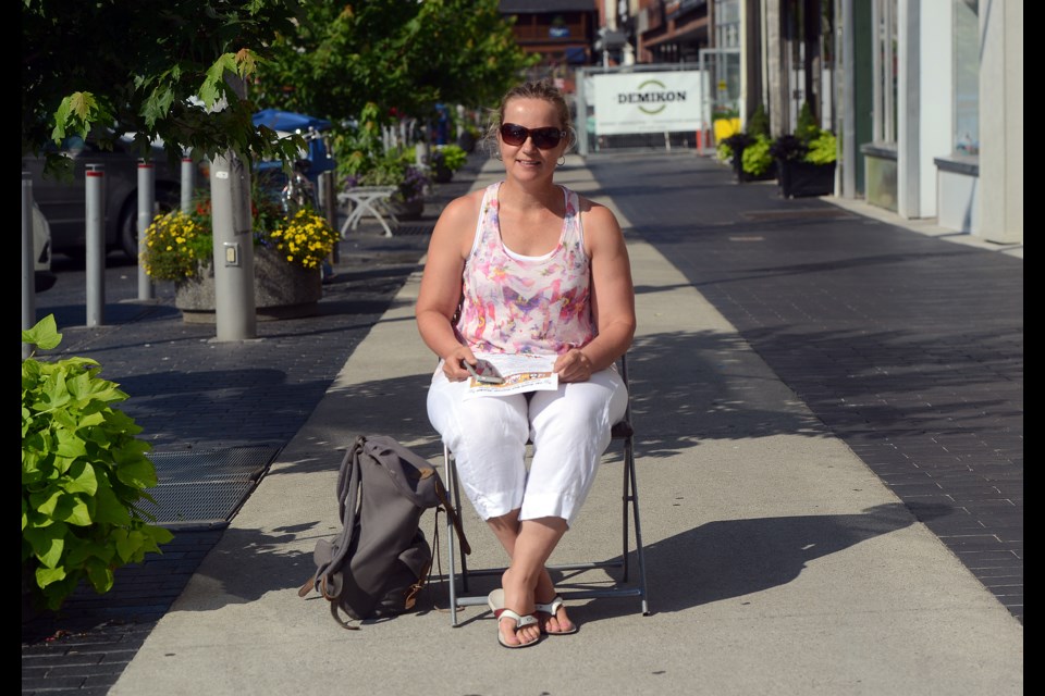 Marie-Jose van der Zande sits on the sidewalk in Downtown Guelph Tuesday, Aug. 1, 2017, one of the many places the Sidewalk Talk initiative will be happening starting later this month. Tony Saxon/GuelphToday
