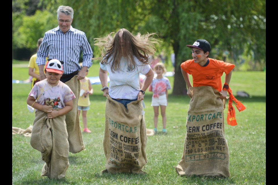 Guelph MP Lloyd Longfield trails the pack in a sack race at the Guelph Neighbourhood Support Coalition's All-Camp Day at Waverley Drive Public School Wednesday. Tony Saxon/GuelphToday