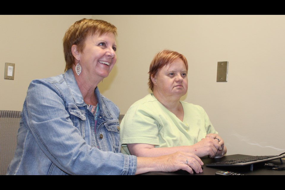 Community Living Guelph-Wellington executive director Cindy Kinnon and Fiona test out one of the new digital hubs.