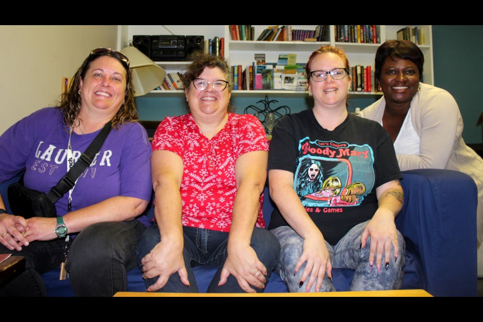 Lynne Kloostra, from left, Jen Quillman, Shauna Brown and Perpetual Osei, workers at the Onward Willow Neighbourhood centre sit in the front foyer in the building that was broken into over the weekend.