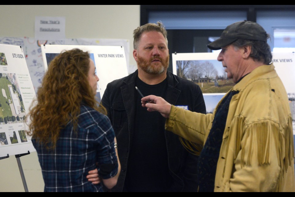 Brendan Johnson, centre, a member of the committee looking to bring a community hub to Brant Avenue, talks with a resident at an open house held Saturday, Feb. 25, 2017, at Brant Avenue Public School. Tony Saxon/GuelphToday