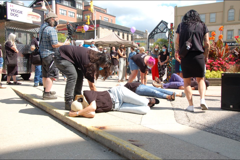 Volunteers were outlined in chalk during a "die-in" to acknowledge local drug poisoning deaths.