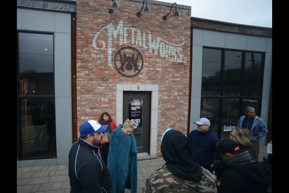 People gather outside the Metalworks sales office Saturday, April 28, 2018, to purchase condos in the third building of the Elizabeth Street development. Tony Saxon/GuelphToday