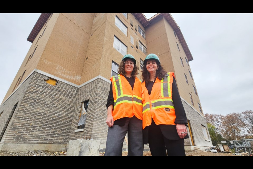 Melissa Kwiatkowski, left, CEO of the Guelph Community Health Centre, and Daria Allan-Ebron, executive director of Kindle Communities, stand outside the building at 10 Shelldale Cresc.