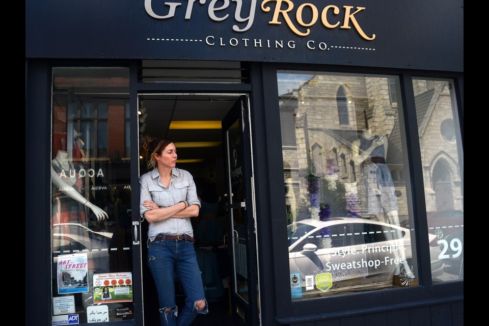 Beth Timlin poses outside Grey Rock Clothing Co. on Quebec Street. The business is for sale to a buyer who wants to maintain the store's ethical standards. Tony Saxon/GueplhToday
