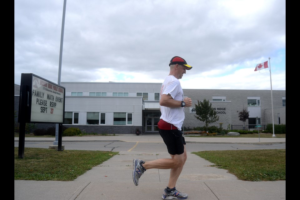 Rickson Ridge teacher Brandon Rees runs a marathon around the school Thursday, Sept. 28, 2017, as part of the school's Terry Fox day activities. Tony Saxon/GuelphToday