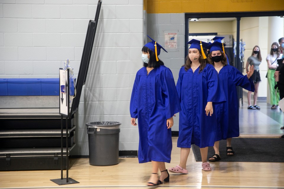 Students walk into the gymnasium at Our Lady of Lourdes Catholic High School in small groups of up to six during indoor graduation ceremonies at that school on Monday. Students graduating from Catholic schools in Guelph will celebrate Monday and Tuesday, while the public board plans to hold graduations in the fall. Kenneth Armstrong/GuelphToday