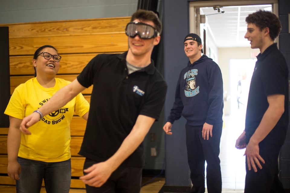 A Bishop Mac student tries to walk a straight line with goggles that approximate the sight of someone impaired during the Sweet Life Road Show held Tuesday at Bishop Mac high school. Kenneth Armstrong/GuelphToday