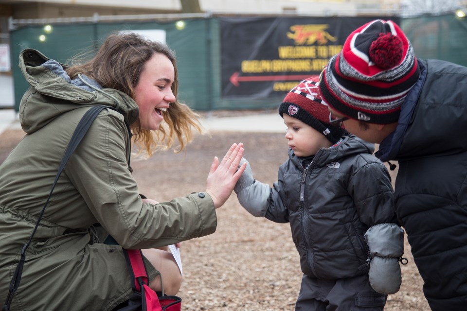 A preschooler from the University of Guelph Child Care and Learning Centre gets a high-five after handing a 'good luck' card to a university student prior to the start of exams. Kenneth Armstrong/GuelphToday