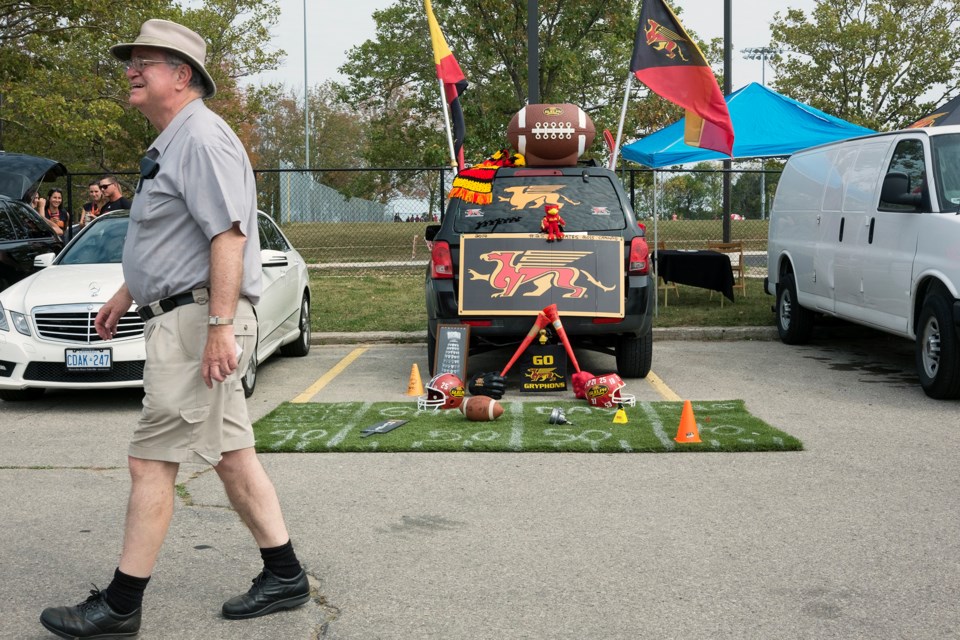 A man walks through an area reserved for University of Guelph alumni immediately  prior to Saturday's football game at Alumni Stadium. Kenneth Armstrong/GuelphToday