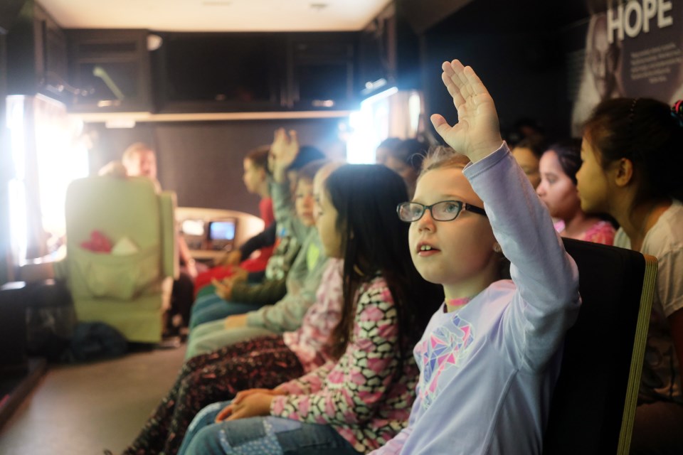 Students in Mr. Kenney's Grade 4-5 class at Mitchell Woods Public School engage in a discussion during the Tour for Humanity travelling exhibit on Wednesday. Kenneth Armstrong/GuelphToday