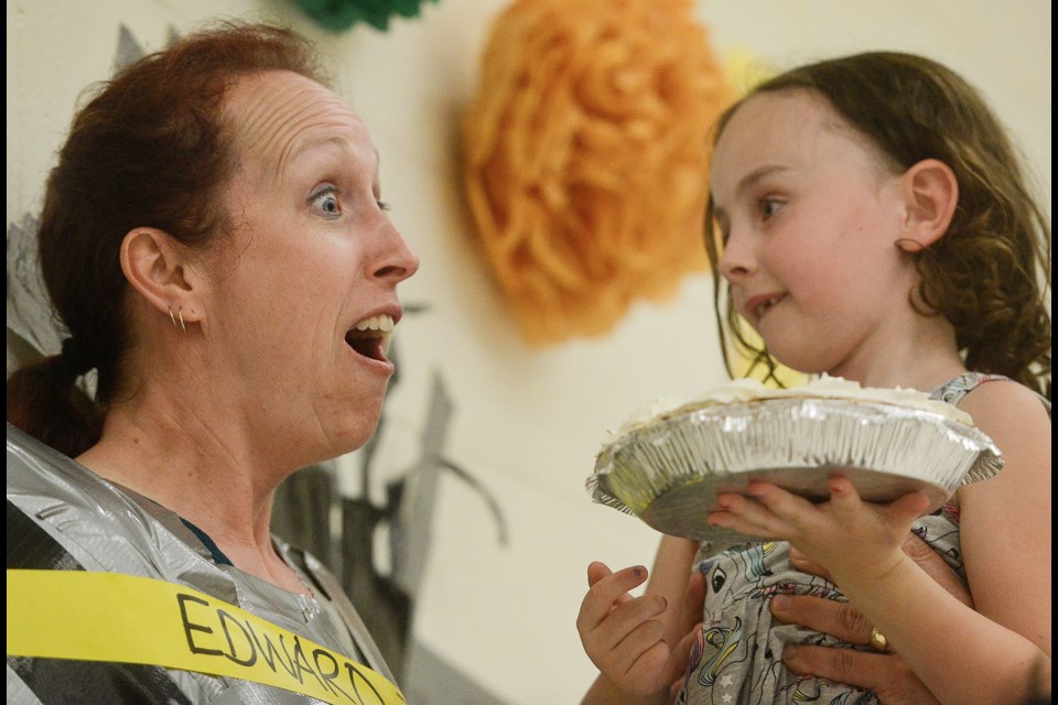 Grade 1 student Lola Antler gets ready to put a pie in the face of teacher Victoria Motto at L'Ecole Edward Johnson Public School Tuesday, June 12, 2018. Tony Saxon/GuelphToday