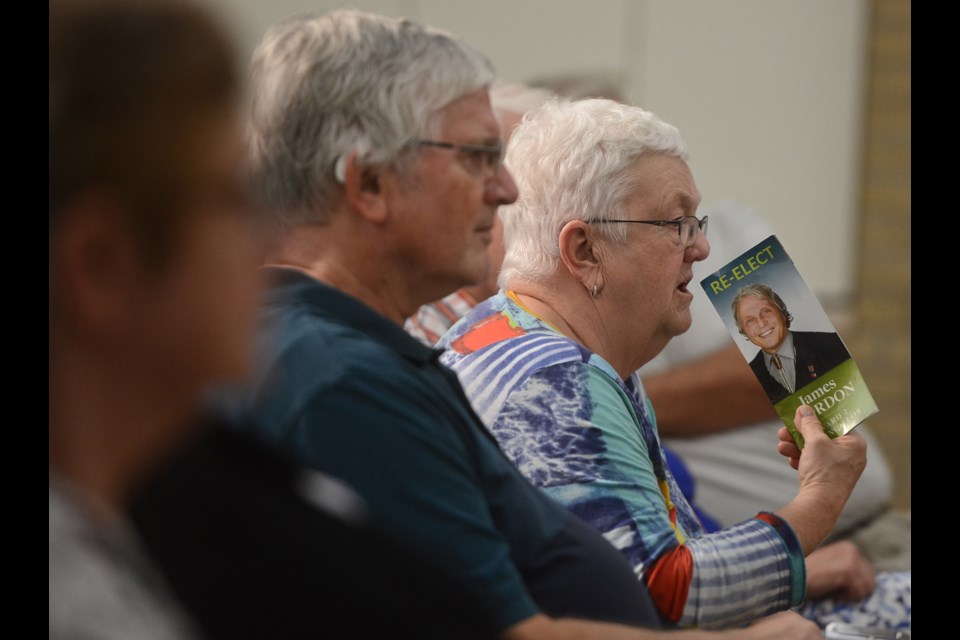 A woman fans herself with some campaign literature in a very warm First Baptist Church hall for the Ward 2 town hall meeting Wednesday night. Tony Saxon/GuelphToday