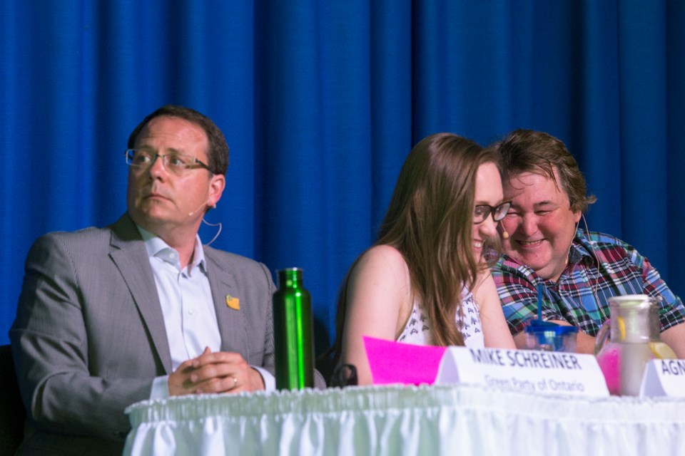 NDP candidate Aggie Mlynarz and Paul Taylor of the None of the Above Party share a laugh while Green Party leader Mike Schreiner looks on during Tuesday's debate at College Heights. Kenneth Armstrong/GuelphToday