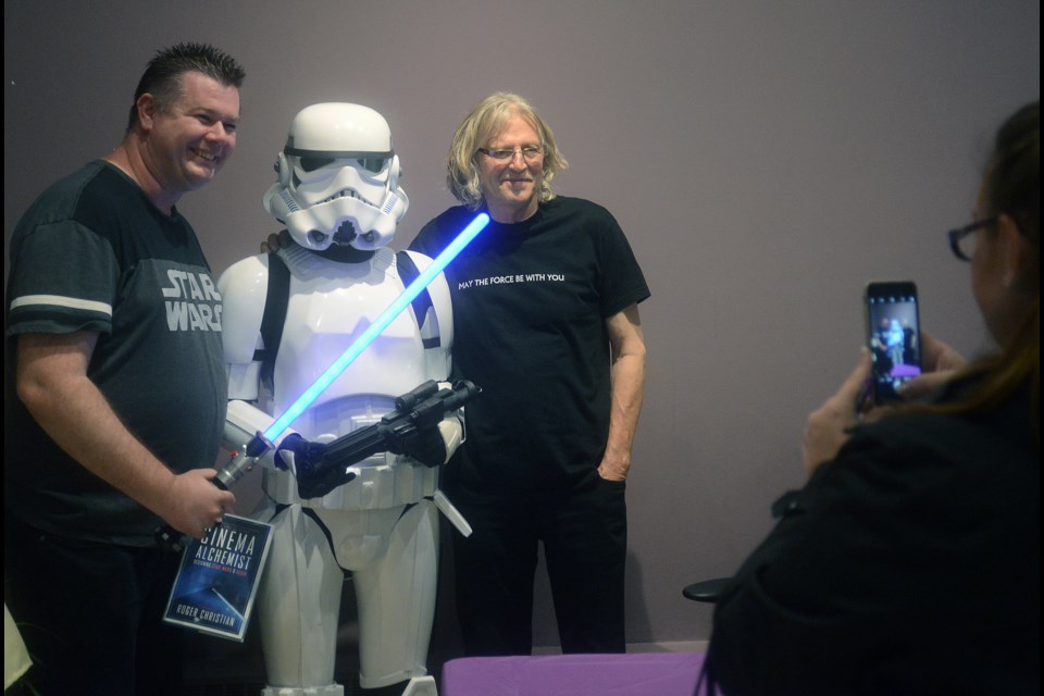 Roger Christian, who helped create some of the iconic movie props and characters in his work on Star Wars, poses with fans and a storm trooper Saturday, Oct. 21, 2017, at the Guelph Public Library. Tony Saxon/GuelphToday