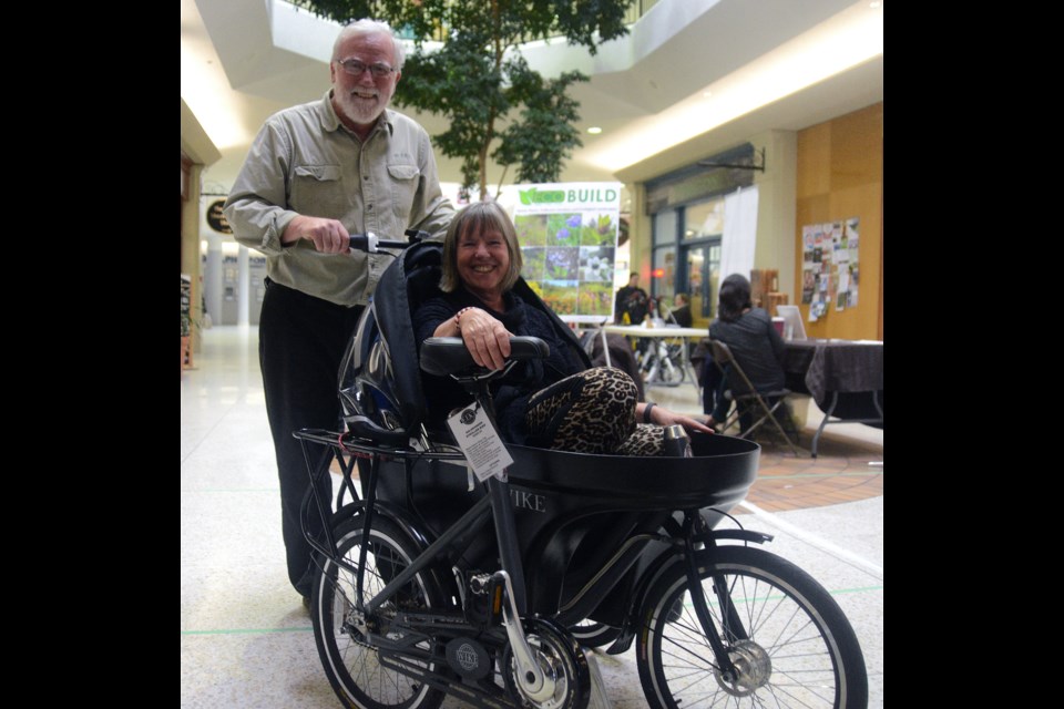 Councillor Bob Bell takes coun. June Hofland for a ride in a Salamander at an event last summer. Bell's Wike company makes the product, which converts from a bicycle cargo/stroller to a hand cargo/stroller and on Thursday night he will pitch it on Dragon's Den. GuelphToday file photo