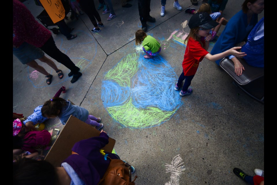 Children chalk at the Climate Action Rally held in St. George's Square on Friday. Tony Saxon/GuelphToday