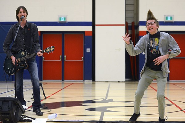 Canadian country music recording artist Ryan Laird, with a little help from a student, performs and presents as part of Wellness Day activities at College Heights Secondary School Friday. Tony Saxon/GuelphToday