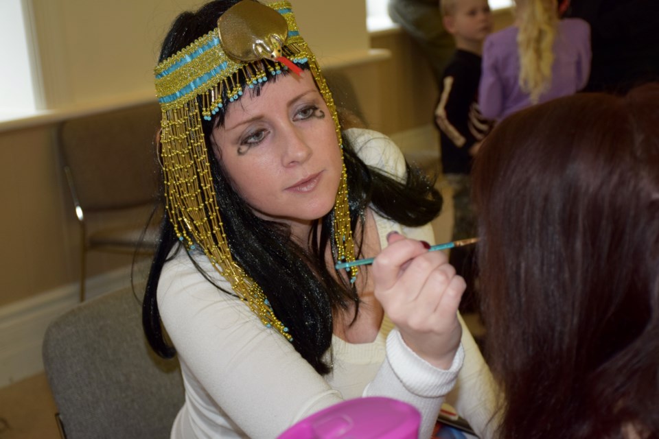 Face painter Lisa Lawless of Lawless Creative applies an Egyptian make-up theme during March Break activities at Wellington County Museum and Archives. 