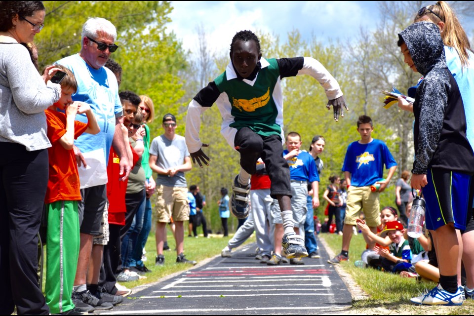 A boy gets airborne during long jump competition at the Special Olympics Track and Field Meet Wednesday. 