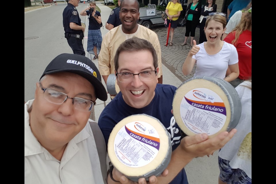 GuelphToday's Tony Saxon and Mayor Cam Guthrie get ready to roll at Festival Italiano Saturday, July 9, 2016. In the background are Guelph Chamber of Commerce CEO Kithio Mwanzia and the mayor' wife Rachel. Tony Saxon/GuelphToday
