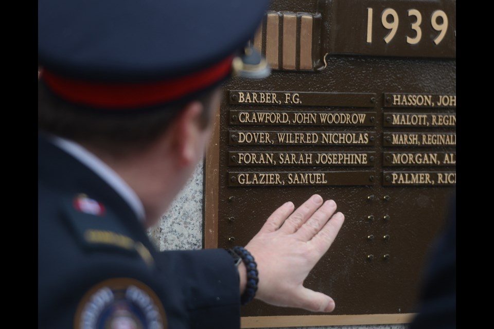 Rev. John Borthwick, who is also chaplain of the Guelph Police Service, looks at some of the names being added. Tony Saxon/GuephToday