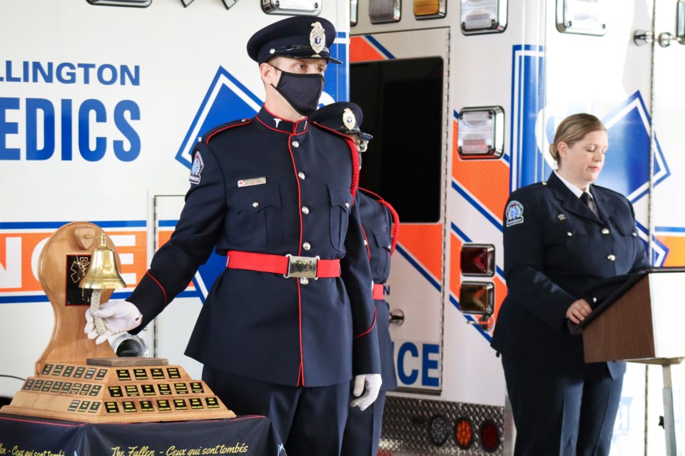 A paramedic holds the rope on the Paramedic Memorial Bell during a cermony Friday at the Clair Road Emergency Services Headquarters. Ariel Deutschmann/GuelphToday