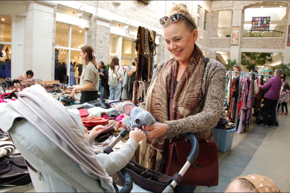 Hosted by Guelph Tool Library, in collaboration with the City of Guelph, Guelph's Largest Clothing Swap + Sale was held at Old Quebec Street Shoppes on Saturday, with more than 7,000 items donated ahead of the event's official start. Here, Vania Zadro shows a knitted hat to her one-year-old grandson Peter Bell.