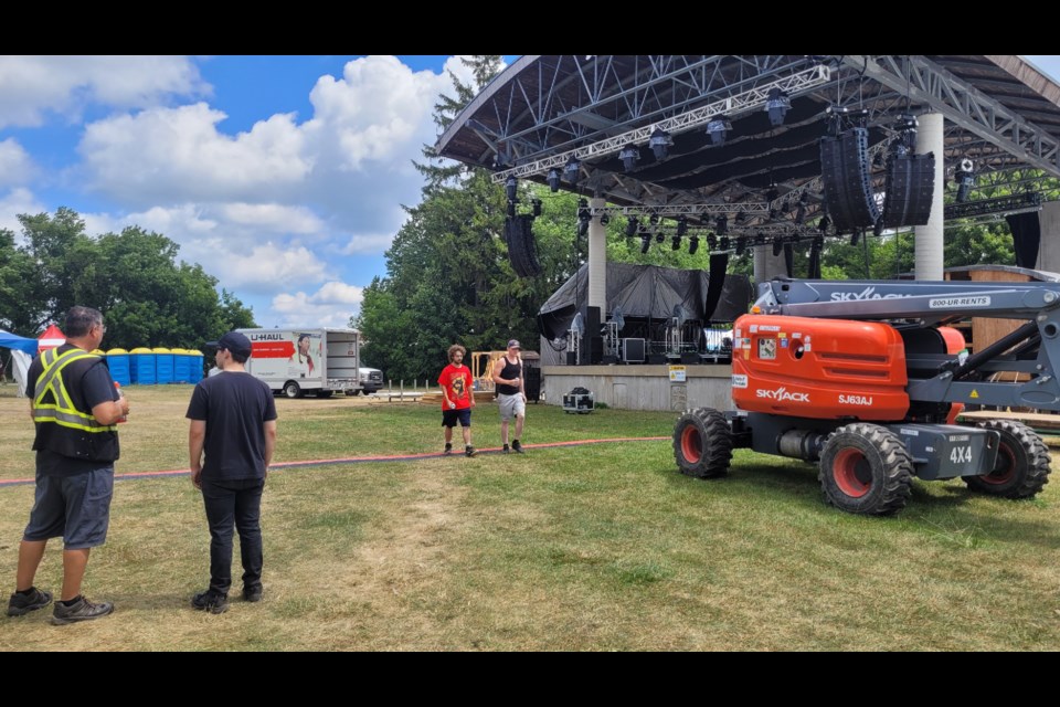 Construction crews survey the scene in front of the main stage ahead of the 2022 Hillside Festival.