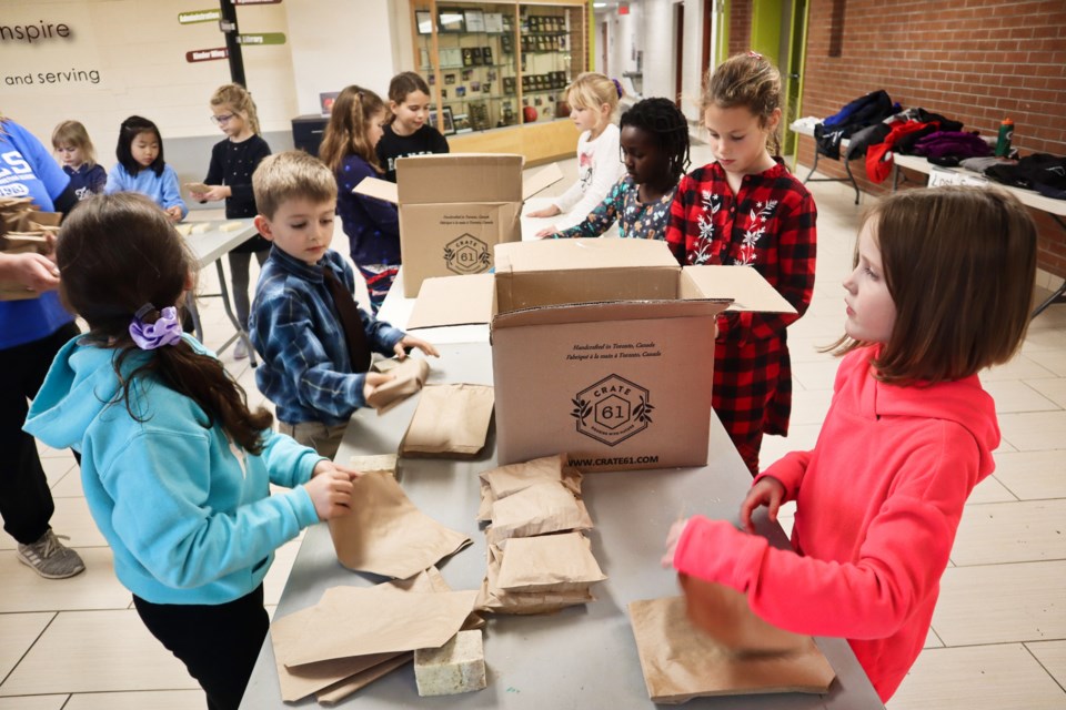 Fifteen students from the Grade 3/2 class at Guelph Community Christian School help to package soap.