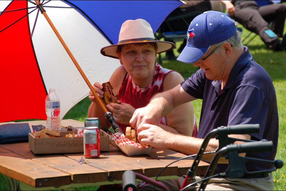 Exhibition Park was a busy place on Sunday for the 2023 BIG Downtown Food Truck Picnic. The event raised funds for Big Brothers Big Sisters of Guelph. Here, Annette and Ian Clutton sit down to eat after visiting a food truck.