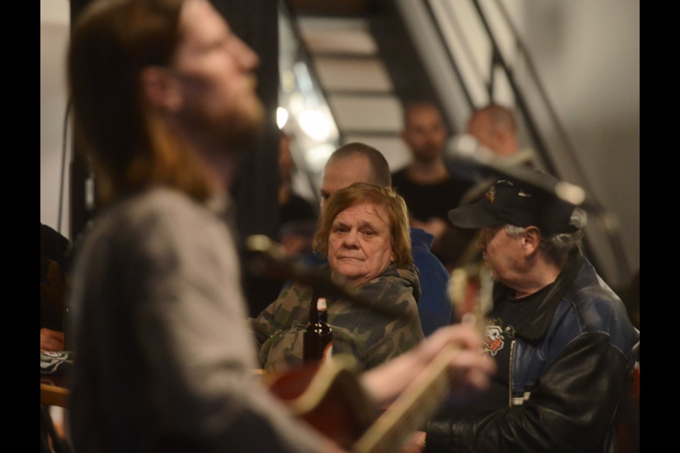 A person watches Stephen Parkinson perform at Red Papaya as part of Music Weekends on Saturday. Tony Saxon/GuelphToday