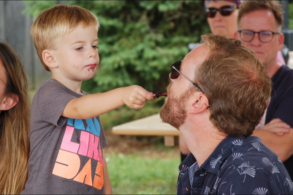 Carter Blake, 3, feeds some of his messy popsicle to his dad, Justin. Held at The Junction on Edinburgh Road Sunday afternoon, Junction Streetfest gathered a crowd. The event, held in support of KidsAbility, featured live music, food trucks and a variety of family friendly activities. It raised $12,500.