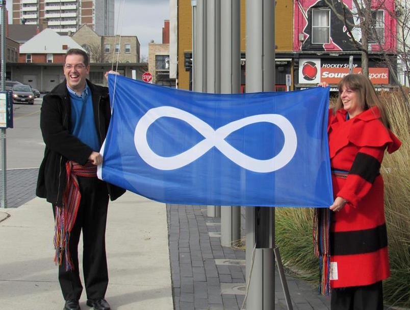 Guelph Mayor Cam Guthrie and Grand River Métis Council president Jennifer Parkinson with the Métis flag during last year's Louis Riel Day in Guelph. (Facebook Image)