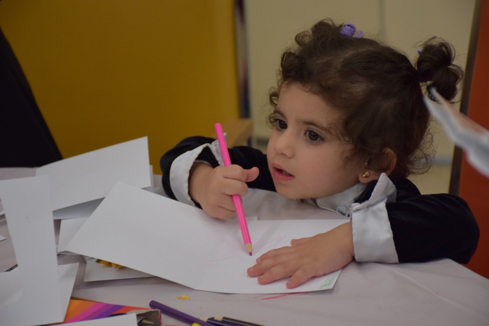 Mayam Alali, 1, made greeting cards at a Christmas party put on for Syrian refugee families and their sponsors on Saturday at the First Baptist Church. Rob O'Flanagan/GuelphToday