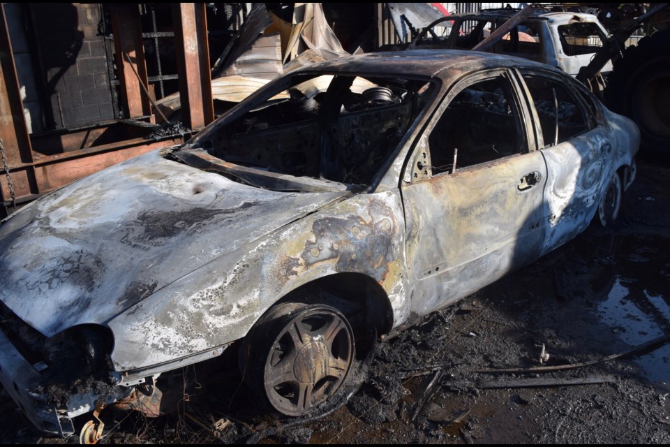 One of several burned out vehicles at the rear of the main Nicklin Auto Parts and Recyclers building. (Rob O'Flanagan/GuelphToday)