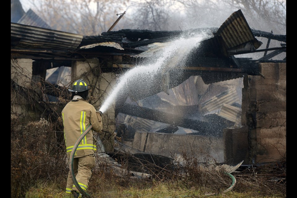 Guelph firefighters work on some remaining hot spots at a barn fire at 7070 Fife Rd. that broke out in the early hours of Monday, Dec. 5, 2016. Tony Saxon/GuelphToday