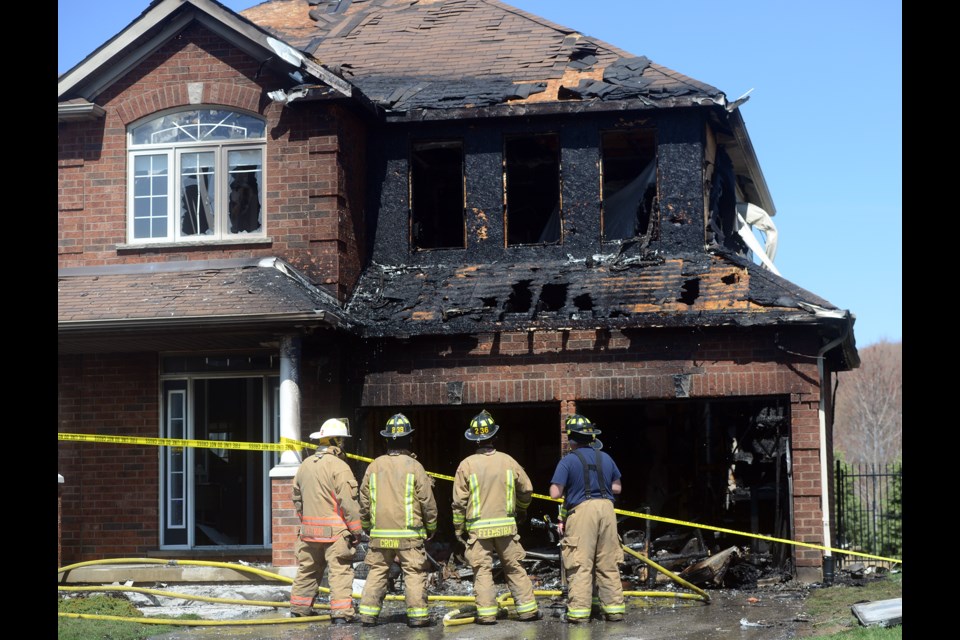 Firefighters survey the damage at 108 Parkinson Dr. in Rockwood after a midday fire badly damaged the home Tuesday, April 18, 2017. Tony Saxon/GuelphToday