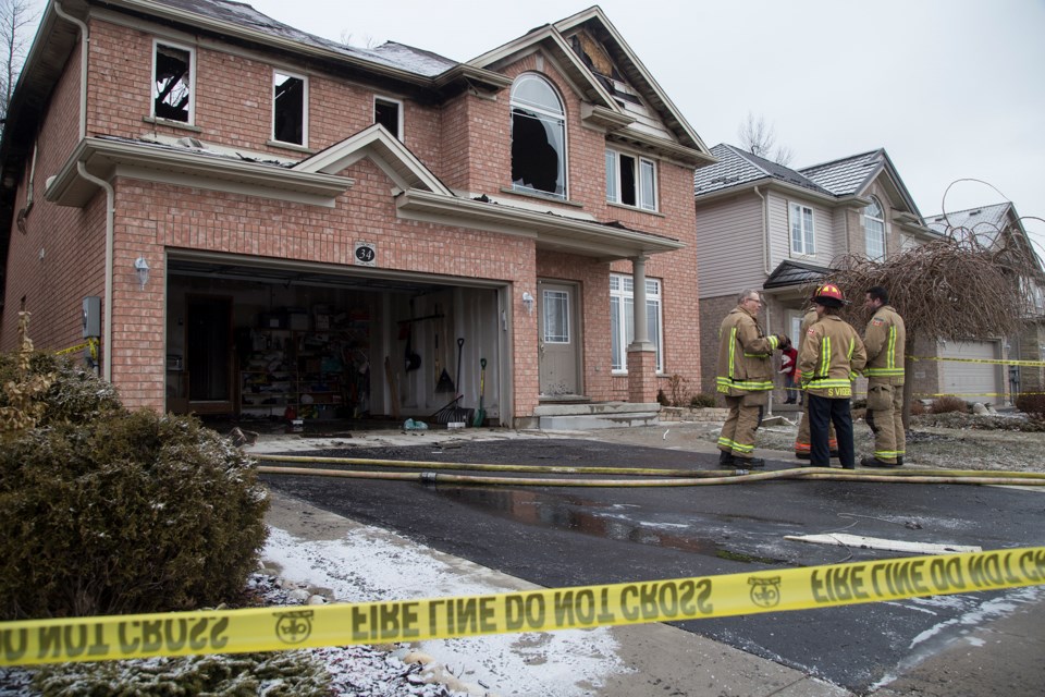 Firefighters with the Guelph Fire Department at the scene Wednesday morning of a house fire that happened overnight on Tovell Drive.