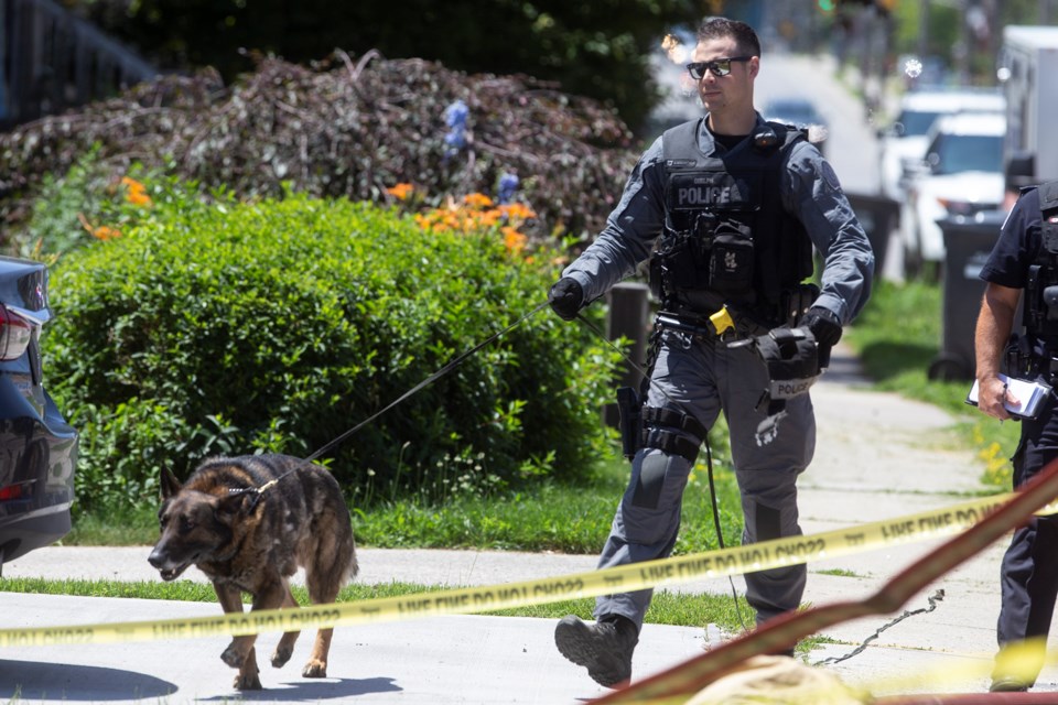 A Canine Unit with the Guelph Police Service is shown the scene of a fire Friday at 191 Elizabeth St. Kenneth Armstrong/GuelphToday 