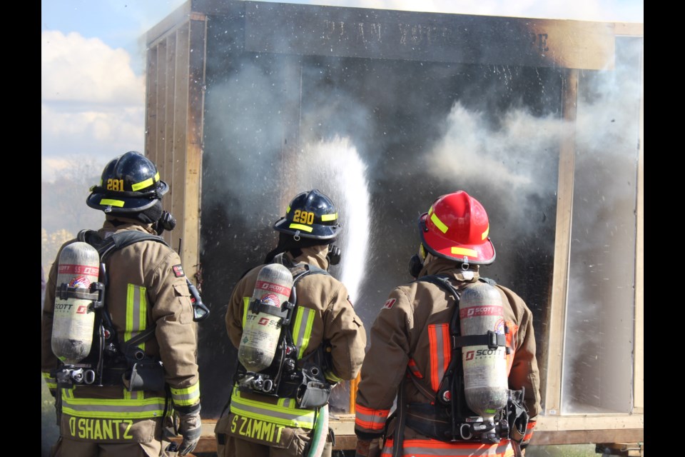 Fire fighters put out the controlled burning demonstration.