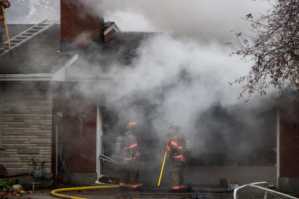 Firefighters with the Centre Wellington Fire Rescue Services respond to a garage fire at a house in Pilkington Township, near Elora. Dan R. Gray for GuelphToday